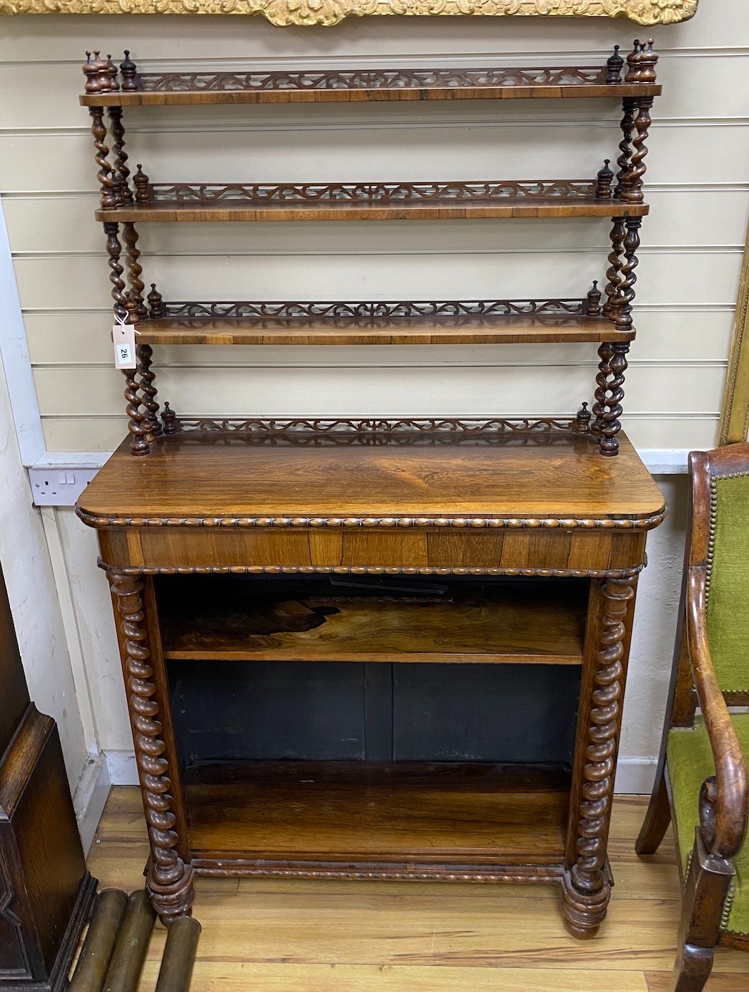 An early Victorian rosewood open bookcase with spiral turned fretwork superstructure, width 92cm, depth 36cm, height 156cm